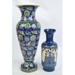 An Iznik/Kutahya type large baluster vase with stylised flower and foliage decoration on blue