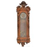 A large 19th century walnut Black Forest rectangular wall clock, the broken arch pediment carved