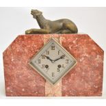 An Art Deco style French marble mantel clock with panther surmount above lozenge shaped silver dial