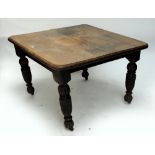 A late Victorian carved oak extending dining table with additional leaf.