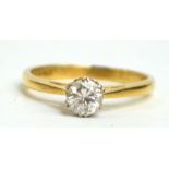 An 18ct yellow gold diamond solitaire ring, the brilliant cut stone of approx 0.33cts, size I.