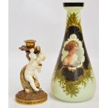 A Moore Brothers gilt heightened candlestick modelled as a cherub beside a stylised grotesque fish