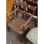 A 19th century yew wood and elm seated open arm elbow chair on turned supports.