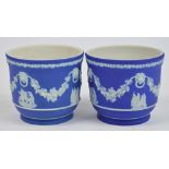 A pair of late 19th/early 20th century Wedgwood blue jasperware small jardinières decorated with