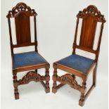 A pair of early 20th century walnut hall chairs in the 18th century manor with padded seat,