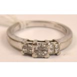 A platinum diamond set ring with three panels each set with four small diamonds, rings size O.