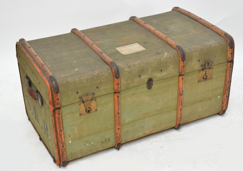 A large vintage wooden bound travelling trunk.