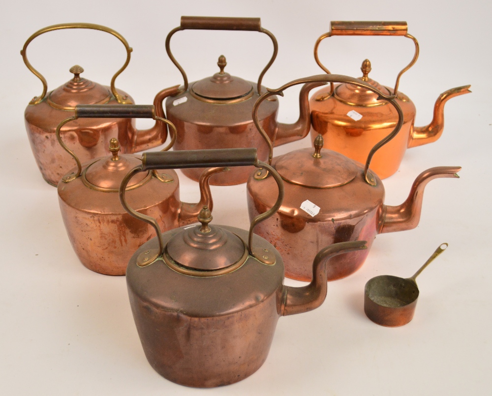 A collection of six copper kettles.