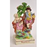 An early to mid 19th century Staffordshire figure of a girl and boy seated on a tree inscribed "