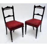 A pair of aesthetic movement ebonised side chairs.