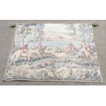 A decorative woven tapestry of a hunting scene with dogs in wooden countryside with mountainous