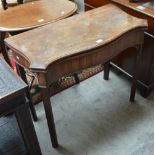 A George III mahogany tea table of serpentine outline.