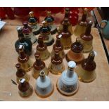 A large quantity of Bell's Old Scotch whisky, ceramic bell decanters (empty), most with stoppers,