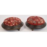 A pair of late Victorian circular ebonised footstools raised on three turned supports, width 30.5cm.