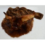 A brown three quarter length fur coat with fur button and shawl collar and a stole with head and