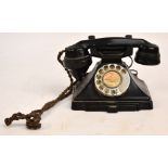 A vintage black telephone with rotary dial, length of handle 23cm. CONDITION REPORT: The left hand