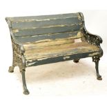 A cast iron painted garden bench with pierced scrolling end supports and simple wooden slats,