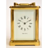 A large mid 20th century brass cased carriage clock with suqre white enamel dial set with Roman