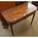 A George III mahogany tea table with D-shaped foldover top raised on fluted square tapering gateleg