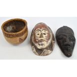 A decorative carved African mask with incised facial pattern and traces of paint, height 27cm,