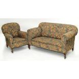 An early 20th century three piece suite comprising drop-arm settee and pair of matching armchairs,