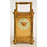 A late 19th century French brass and champlevé enamel decorated carriage clock, with pierced and