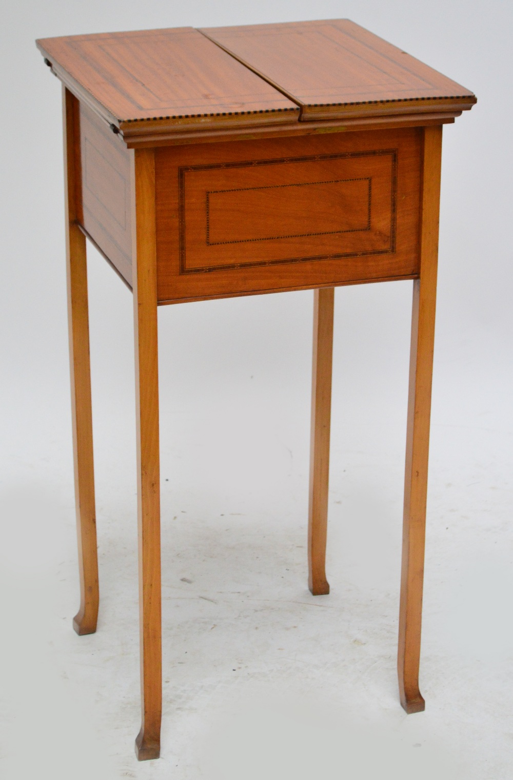 An Edwardian satinwood and inlaid square workbox with twin hinged flaps enclosing fitted interior