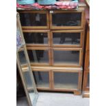 A Minty oak bookcase with four pairs of glazed doors.