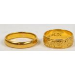 Two 22ct yellow gold wedding bands, one with engraved foliate decoration, approx 8.2g. CONDITION