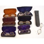 A collection of vintage spectacles in cases (7).