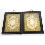 A pair of 19th century plaster medallions of Mary and Christ in ornate gilt threaded floral and