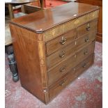 An early 19th century mahogany and inlaid chest of two short and three long drawers with canted