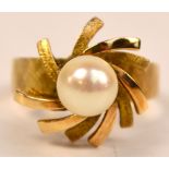 A 14kt American yellow gold dress ring with floral pattern centred with a pearl, size P, approx 5.