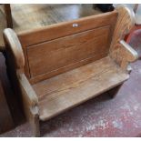 A small pine pew with shaped end section, width 97cm.