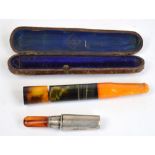 A silver cigarette holder with amber mouthpiece, Birmingham 1929,