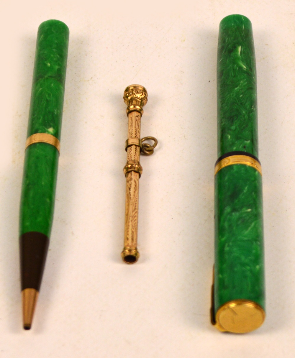 A 1920's Canadian Waterman's Ideal pen and nib with yellow metal self filling mechanism and mounts,