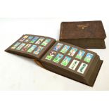 A large collection of cigarette card sets in two albums.