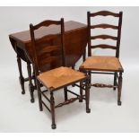 An oak gateleg dropleaf dining table and a set of four rush seated ladder back chairs (5).