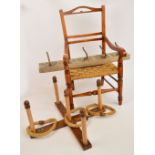 A child's stained beach elbow chair with ring turned supports and stretchers and rush seat and a