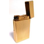 An S.T. Dupont of Paris gold plated lighter.
