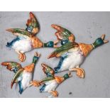 Four graduated wall plaques by Beswick modelled as a group of mallard ducks, length of largest