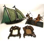 A pair of vintage copper photograph frames decorated with knights on horseback to the top and a