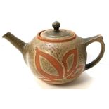 A Simone Kilburn (Troika) teapot decorated with opposing floral motifs, initialled S.