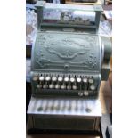 A vintage cash register with raised floral decoration (af). CONDITION REPORT Does not appear to be