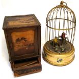A wooden cigarette box with Oriental scenes and a musical automated bird cage (2). CONDITION