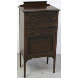 An Edwardian mahogany music cabinet, three upper drawers above a lower fall front hinged cabinet,