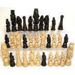 A contemporary set of resin chess pieces modelled on characters from "Alice In Wonderland",