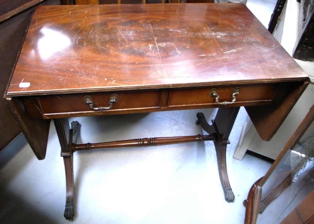 A reproduction mahogany sofa table with ring turned stretcher,