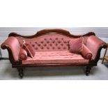 A Victorian walnut framed sofa with curving back and scrolling arms on cabriole legs and castors,