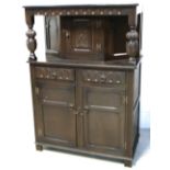 A dark oak priory style cabinet, height 129cm and a matching priory court cupboard, 135 x 92cm (2).